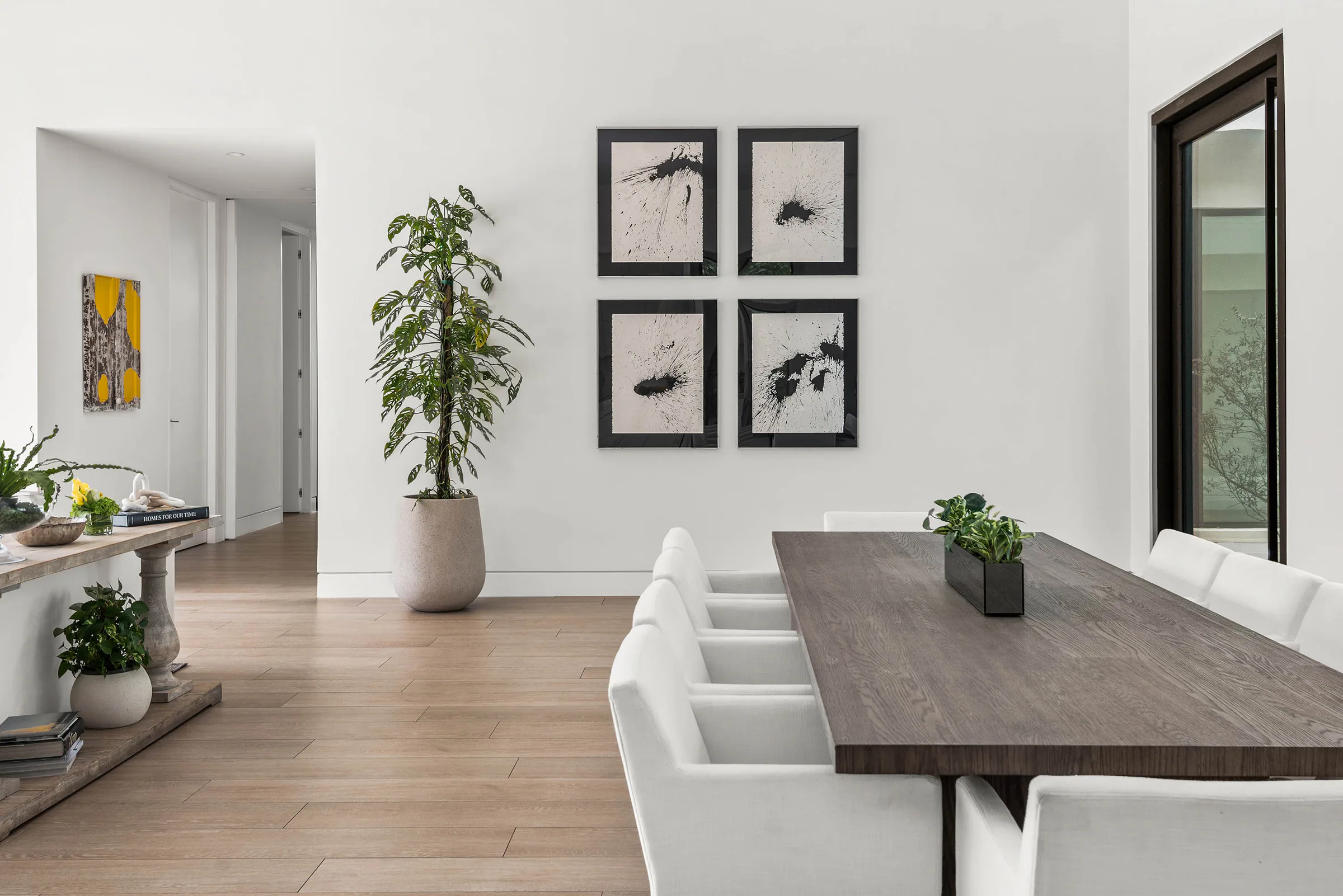 Dining table and white cabinetry in the bright open interior.