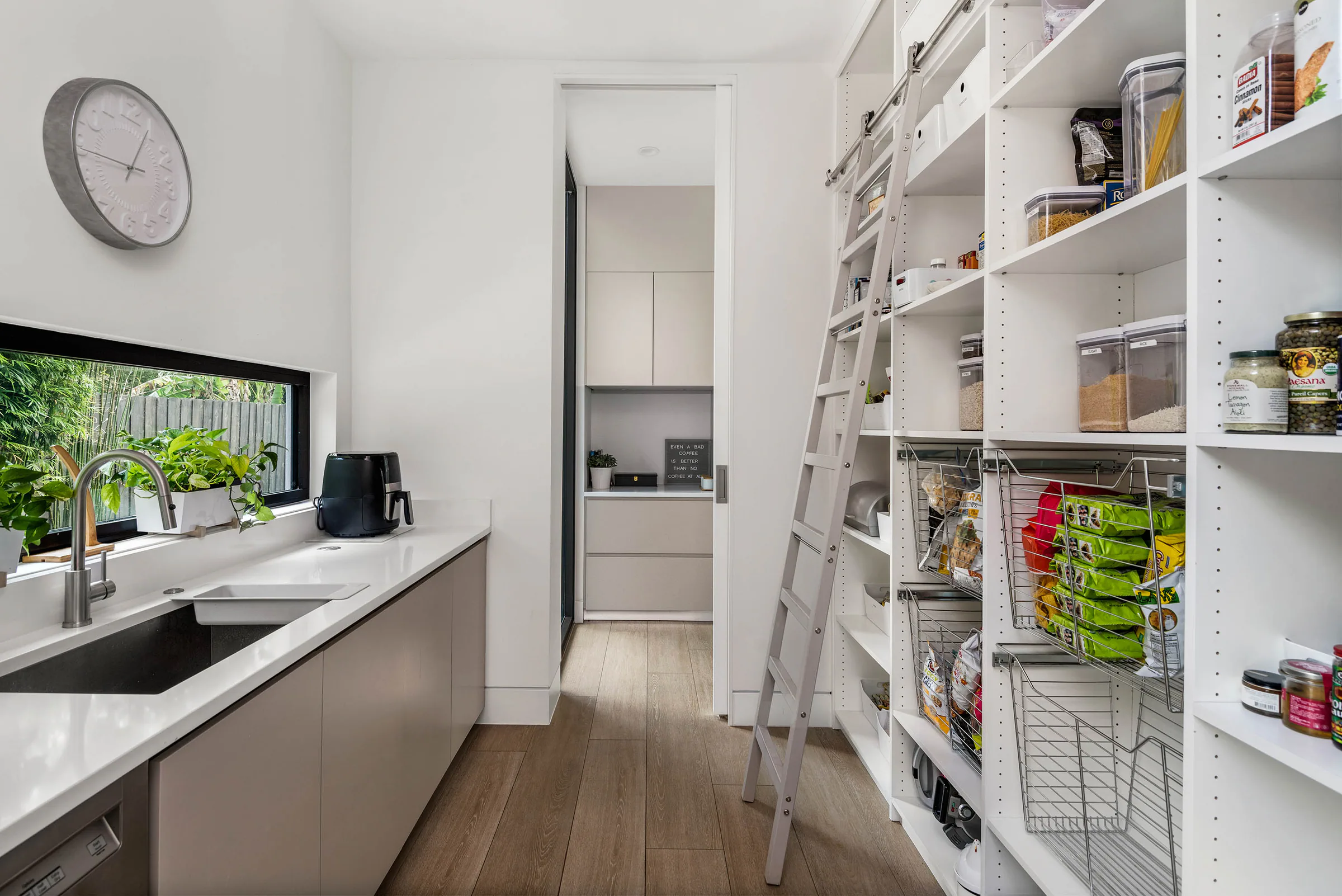 Kitchen work area with open shelving and garden window.
