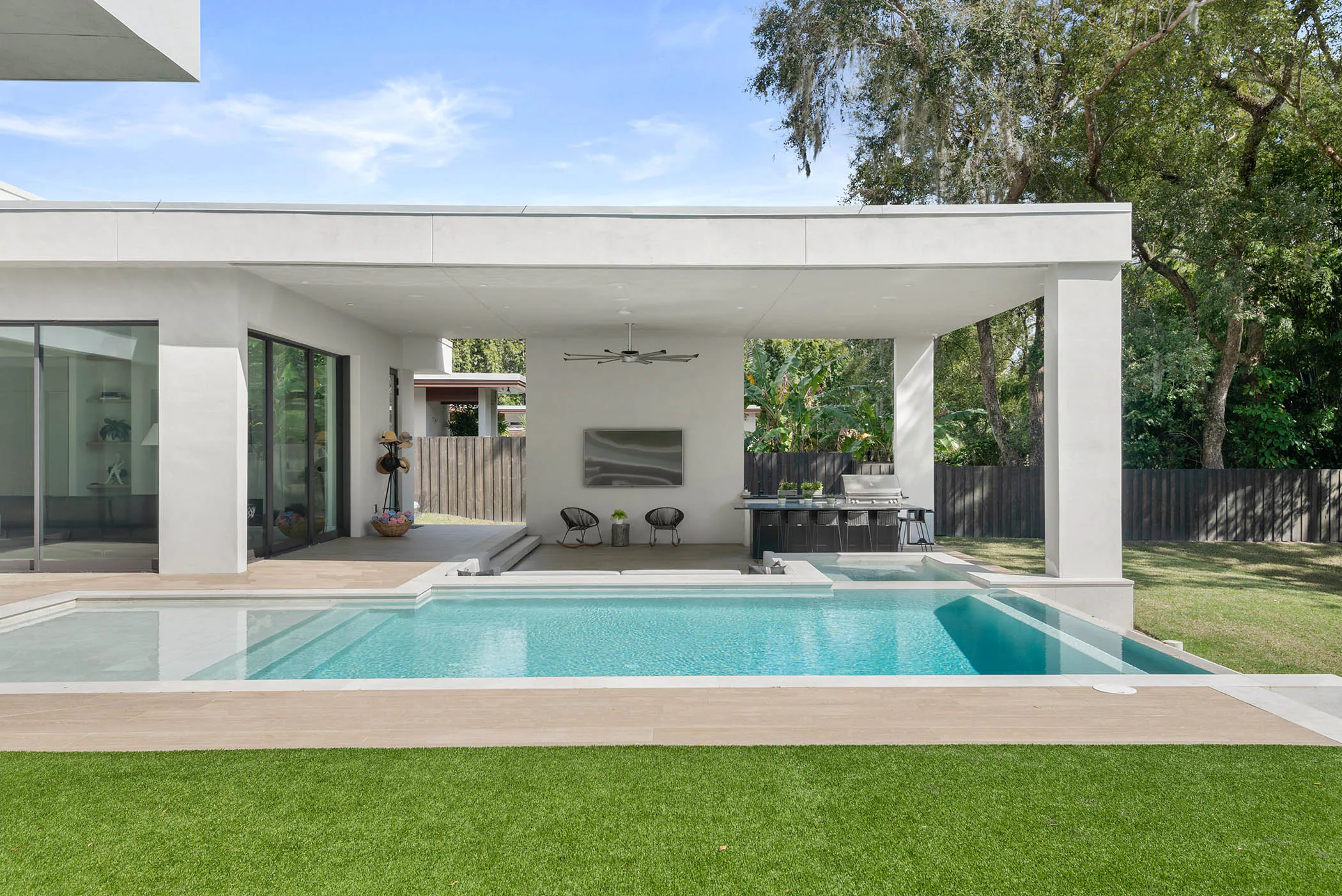 Pool viewed toward the covered rear pavilion. Spring, a custom home by Rare Builders in Orlando.