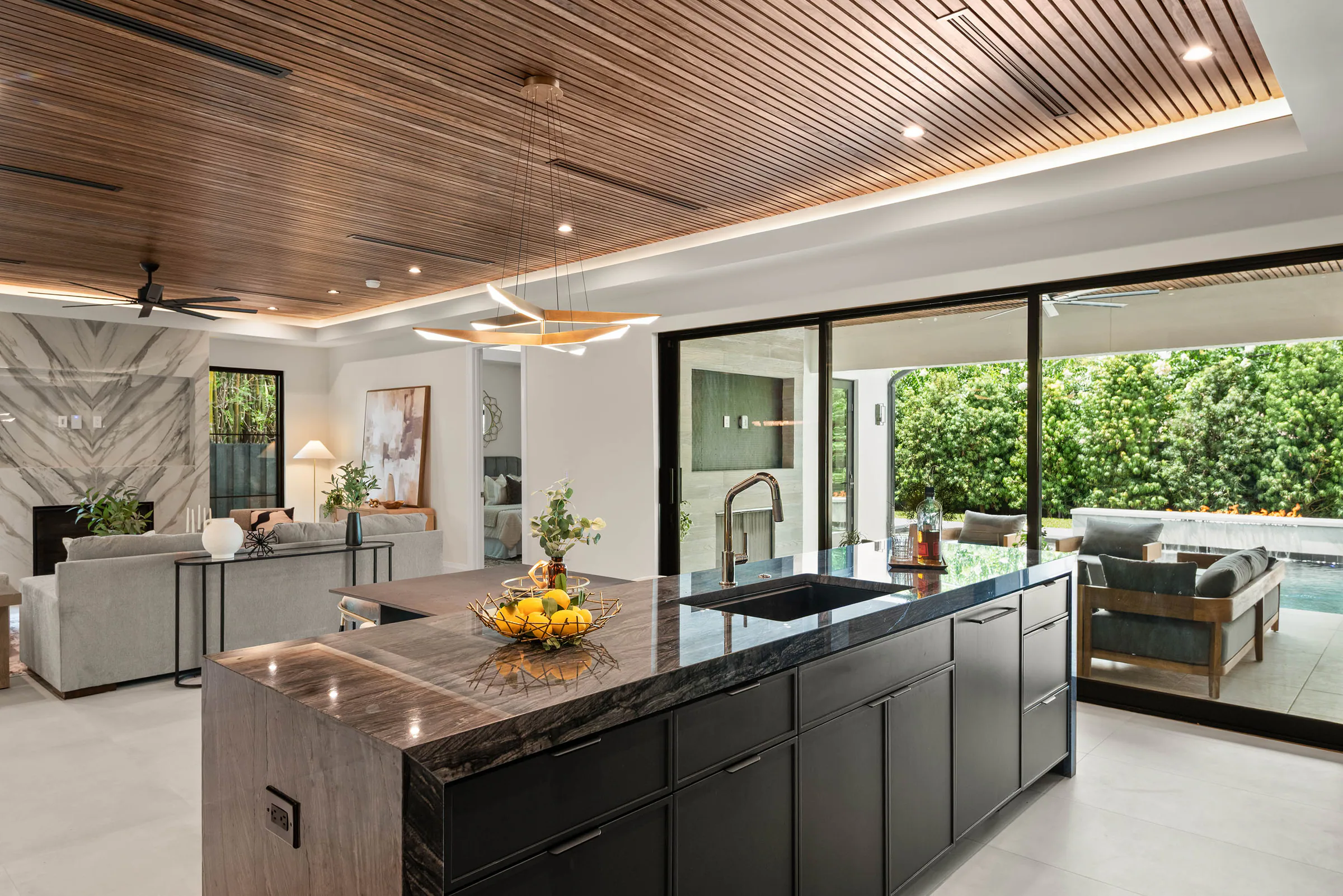 Open kitchen and dining room with garden glazing. Munster, a custom home by Rare Builders in Orlando.