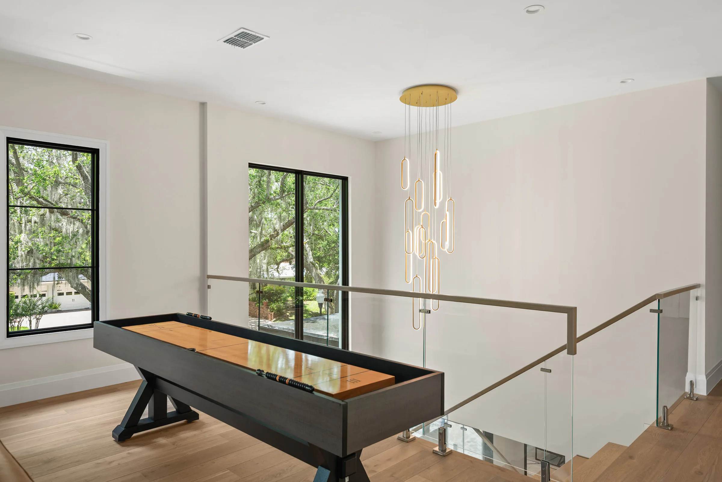 Billiards table beside the upper landing and broad windows.