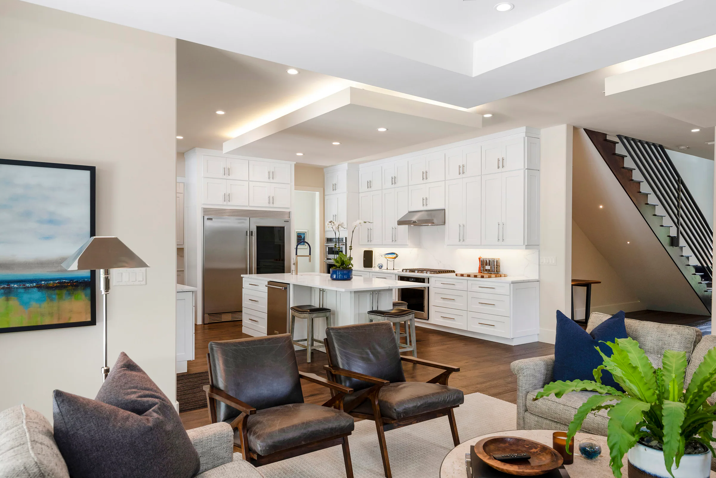 Open kitchen with a white island and adjacent dining area.