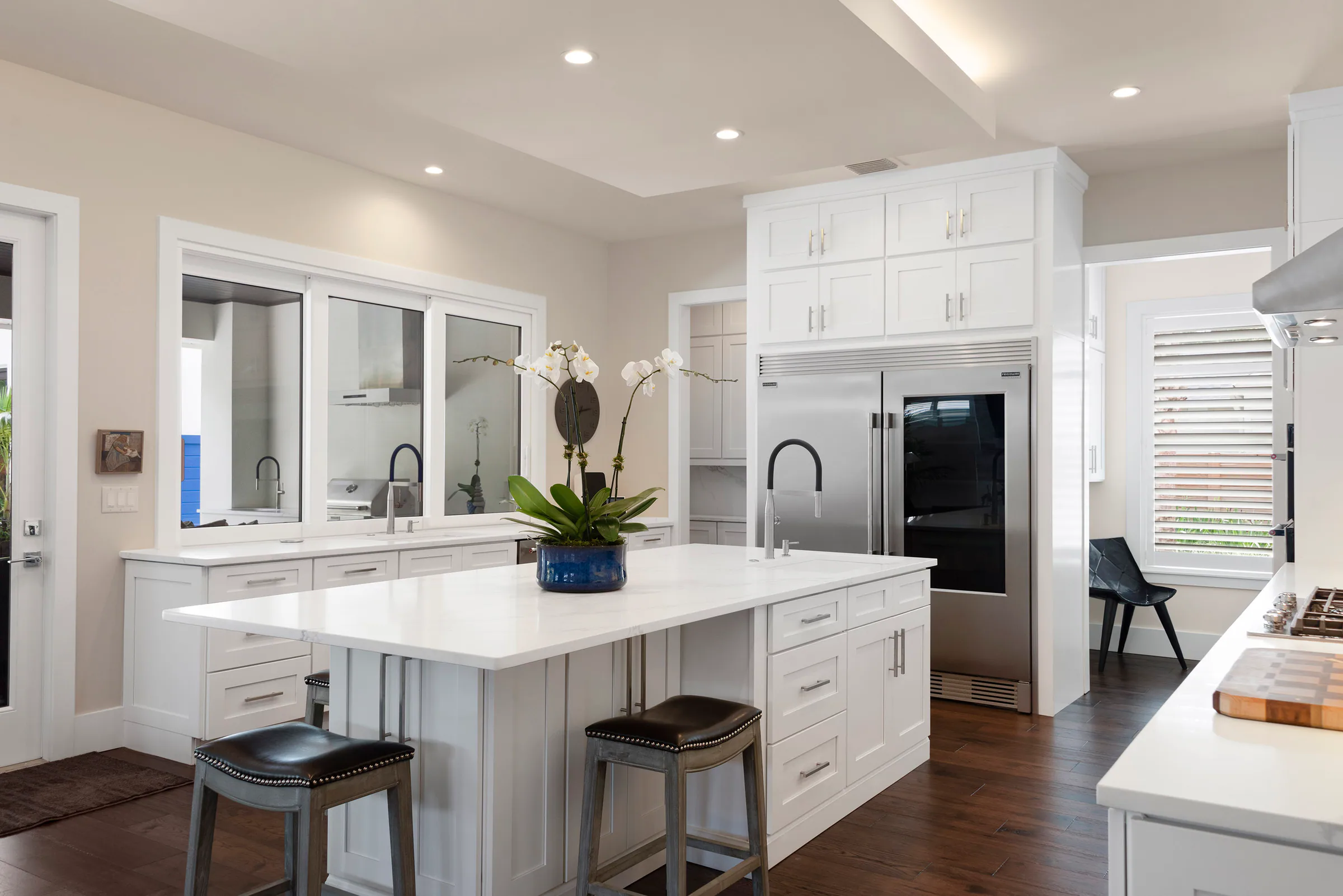 Kitchen with dual refrigerators and white cabinetry. Nottingham, a custom home by Rare Builders in Orlando.