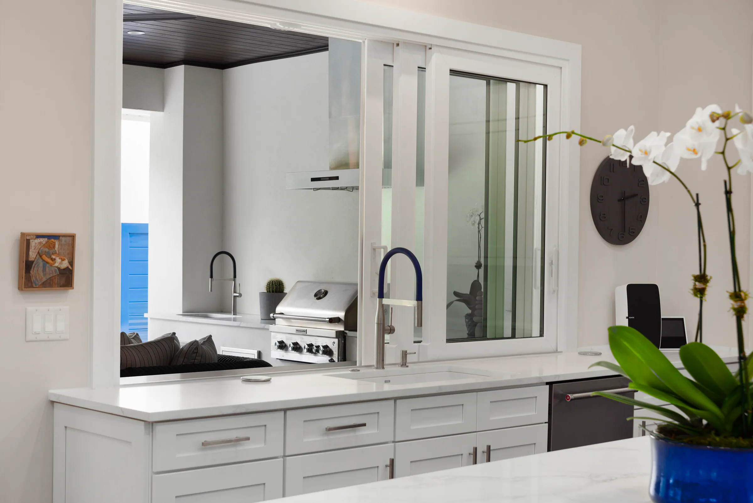 Small white prep sink with a bright blue faucet.