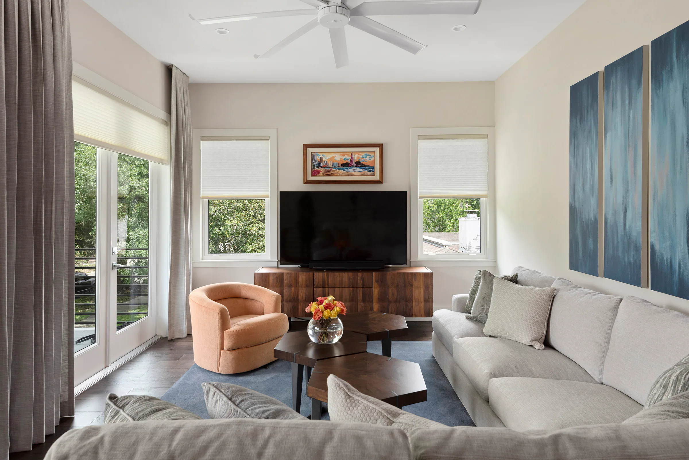 Upstairs lounge with corner windows and a low fireplace. Nottingham, a custom home by Rare Builders in Orlando.