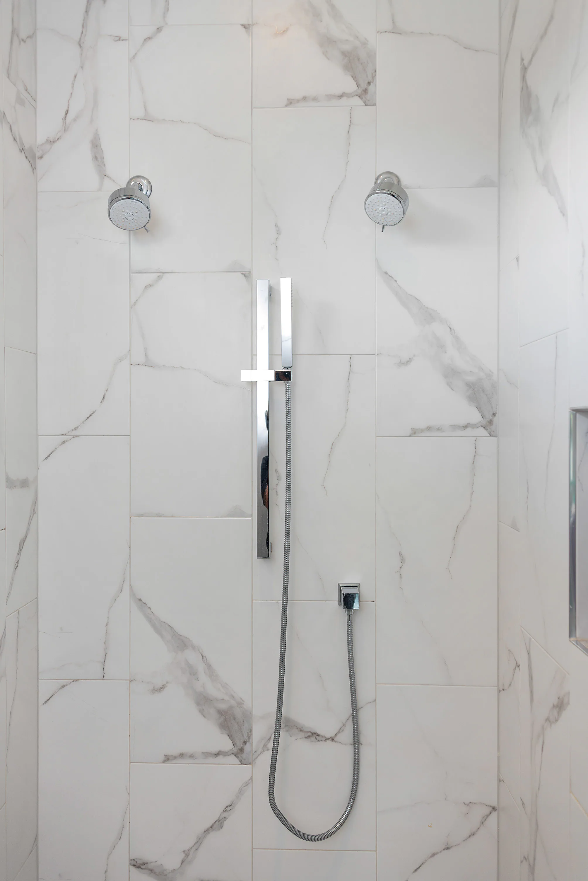 Freestanding tub faucet against a tiled wall.