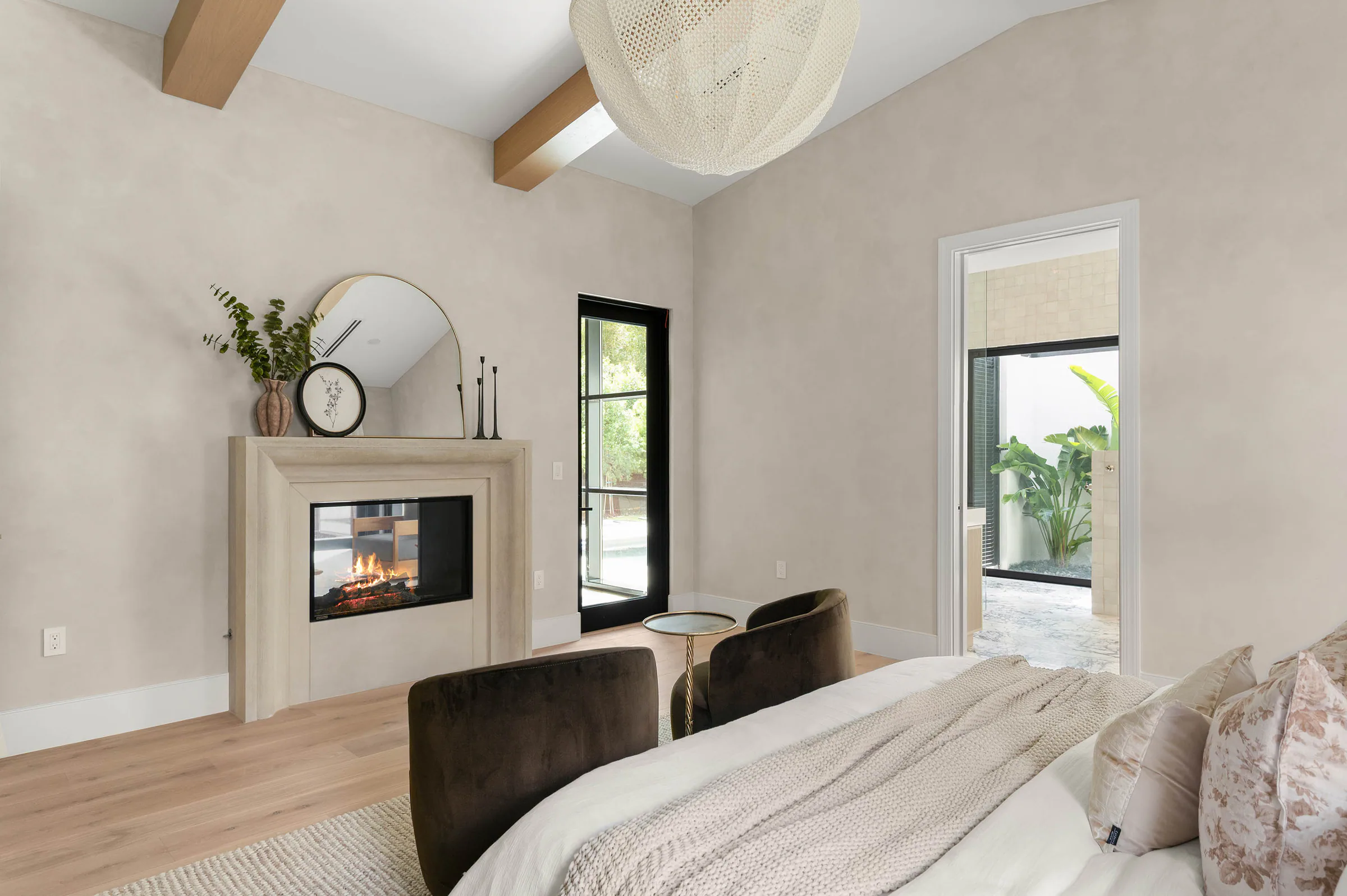 Bedroom seating area beside a fireplace and garden windows. Dana, a custom home by Rare Builders in Orlando.