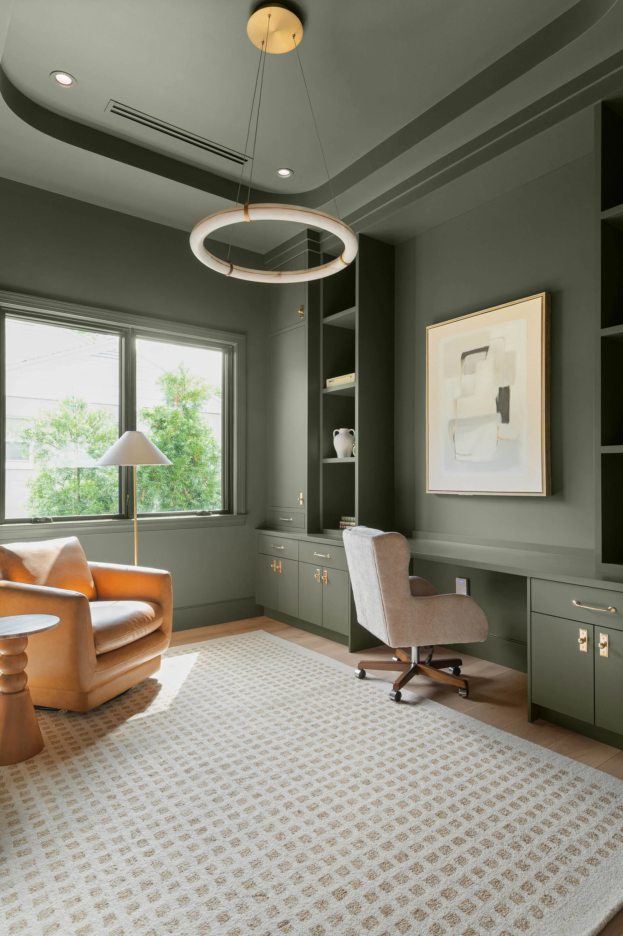 Dark green room with circular ceiling lights and a patterned rug.