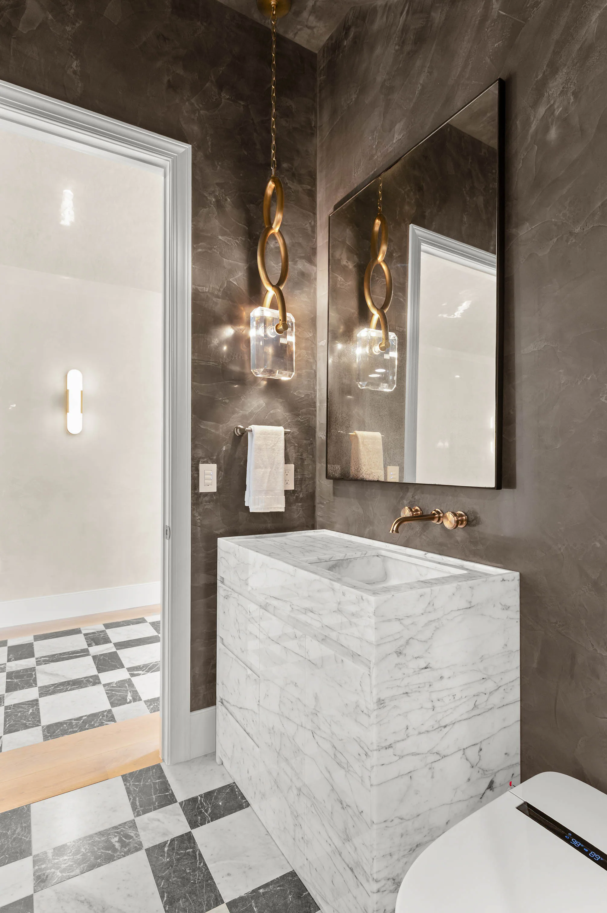 Marble shower with contrasting checkerboard floor tile. Dana, a custom home by Rare Builders in Orlando.