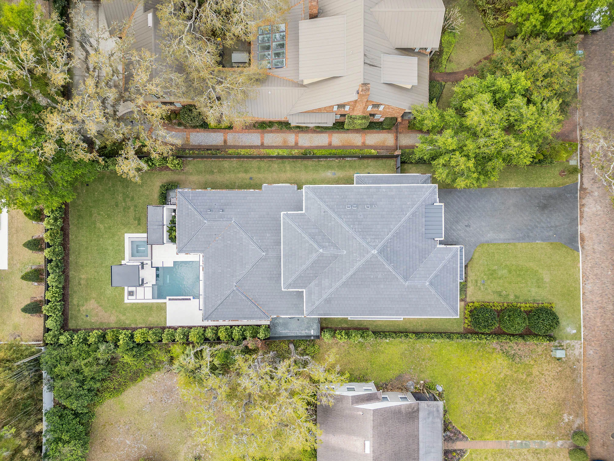 Straight-down aerial view of the residence, lawn and pool.