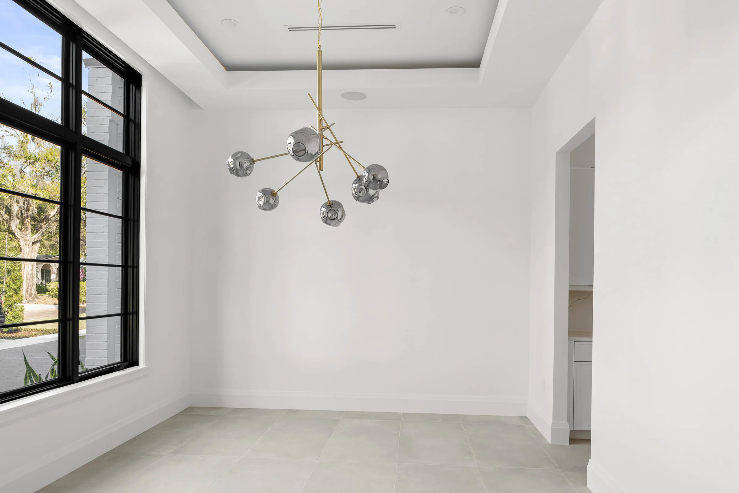 Unfurnished bedroom with a garden window and pendant light.