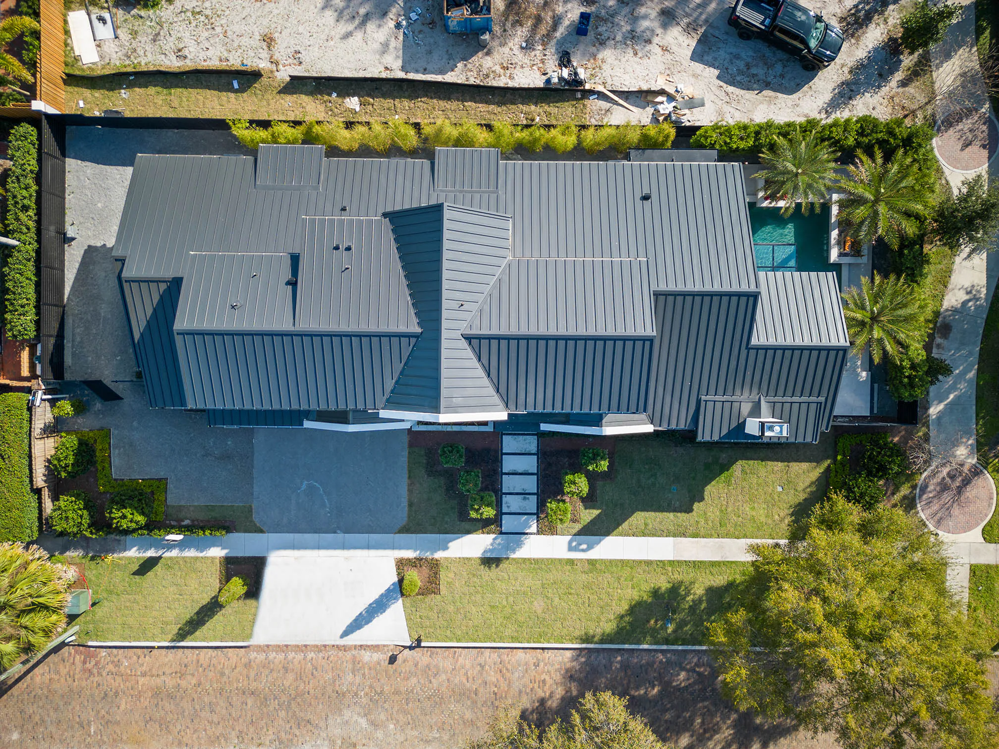 Straight-down aerial view of the residence and pool courtyard.