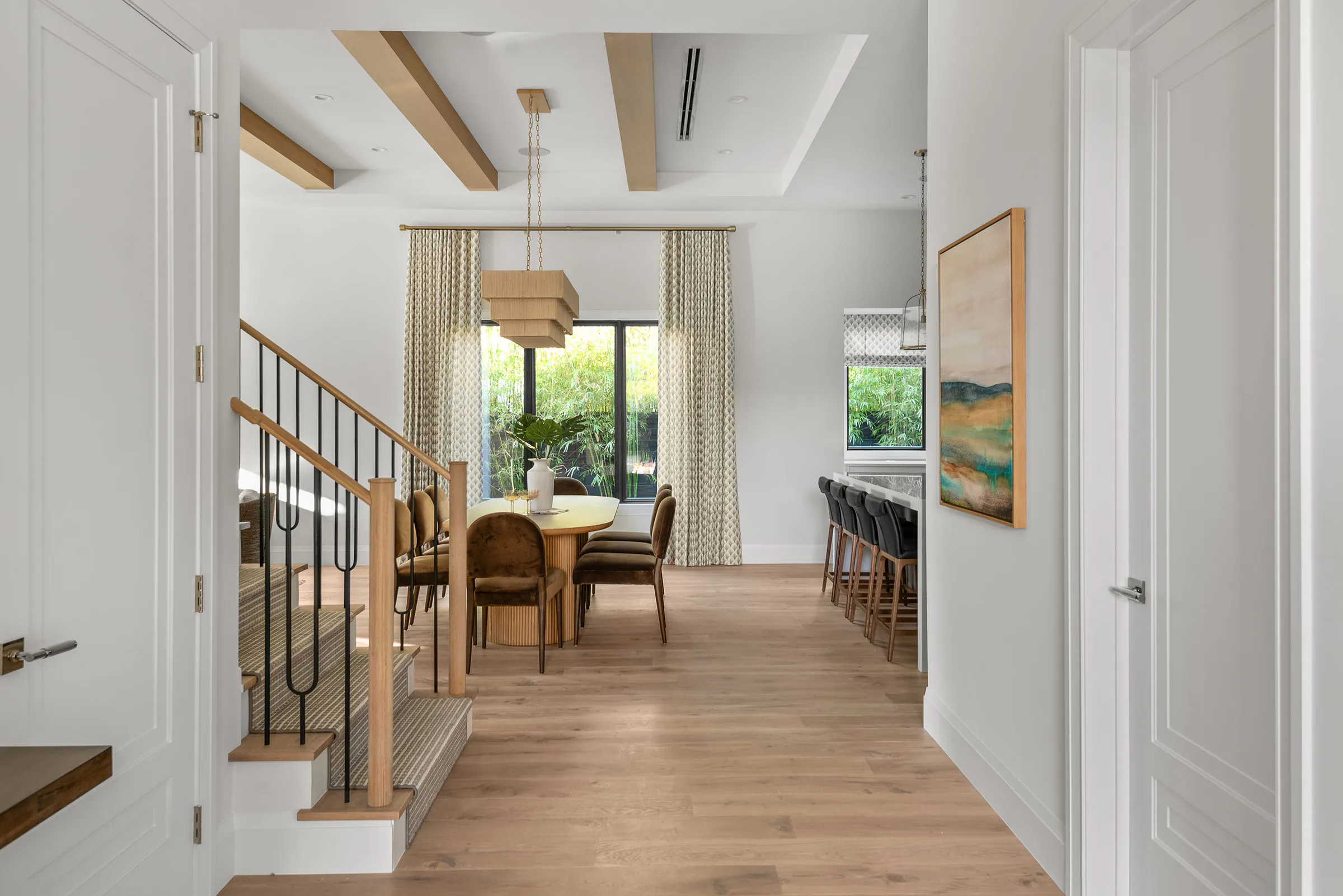 Entry hall with pale oak flooring and a view through to the rear glazing.