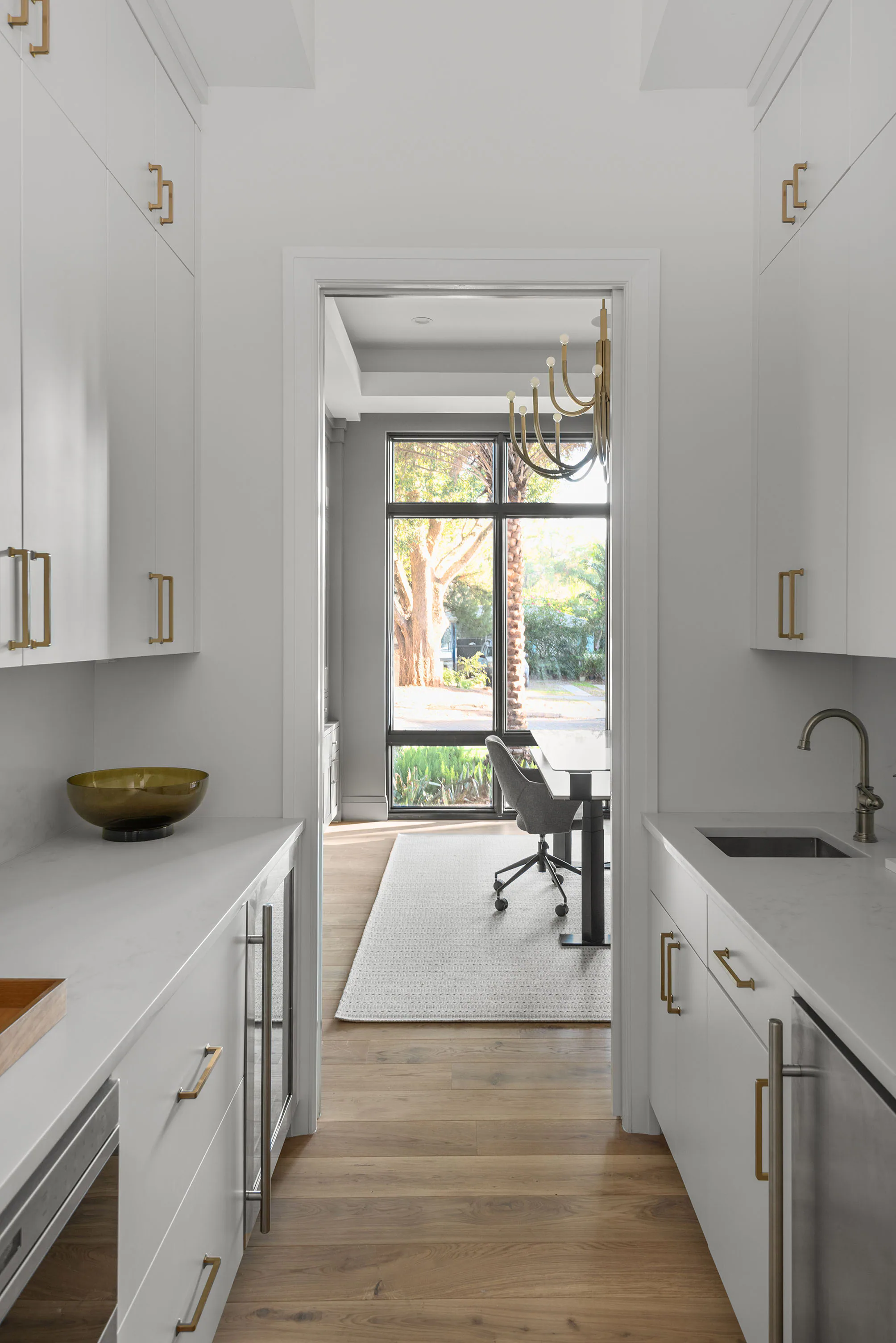 Kitchen work area with green lower cabinetry and a garden window. Rockwood, a custom home by Rare Builders in Orlando.