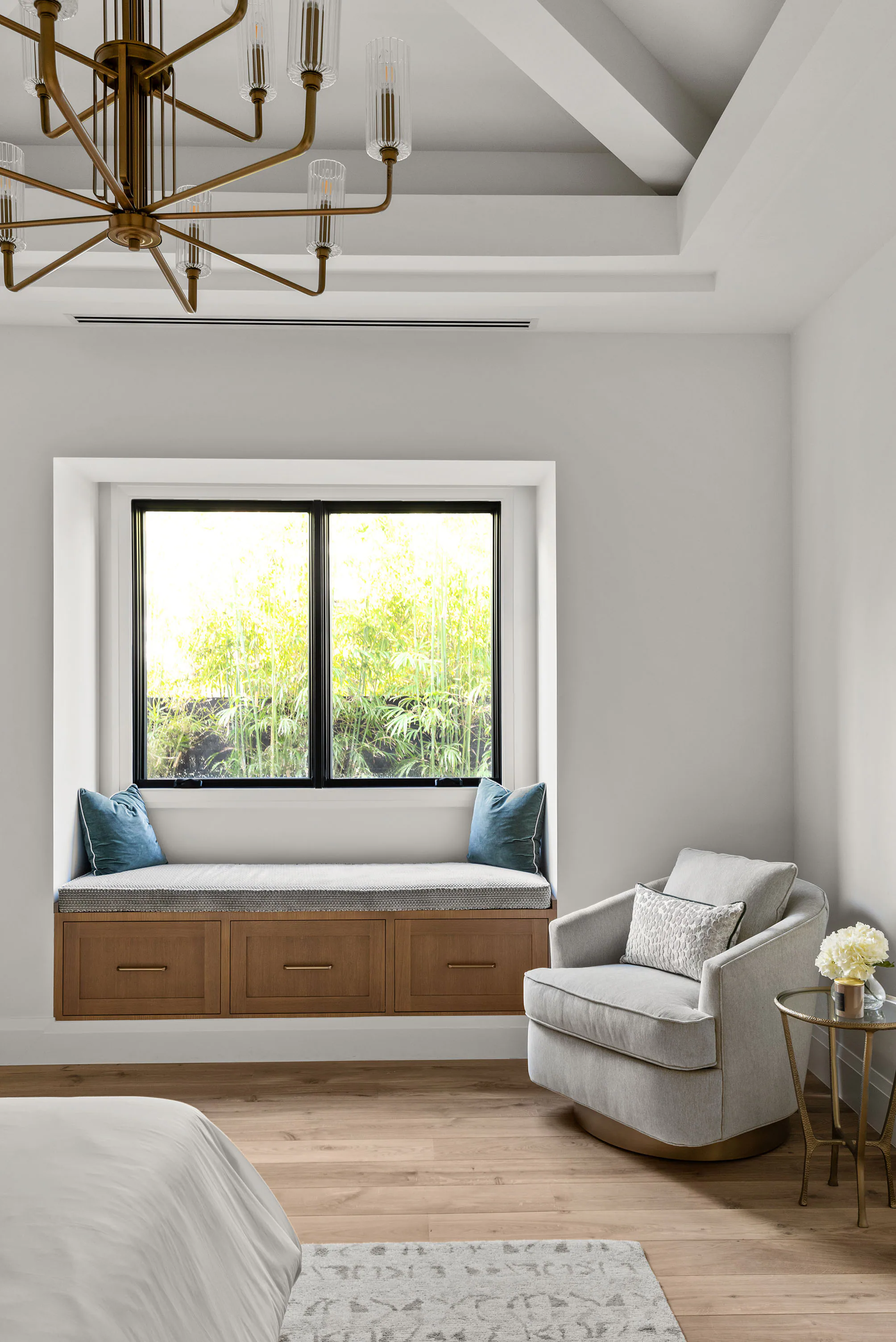 Bedroom with white furnishings and a deep window seat. Rockwood, a custom home by Rare Builders in Orlando.