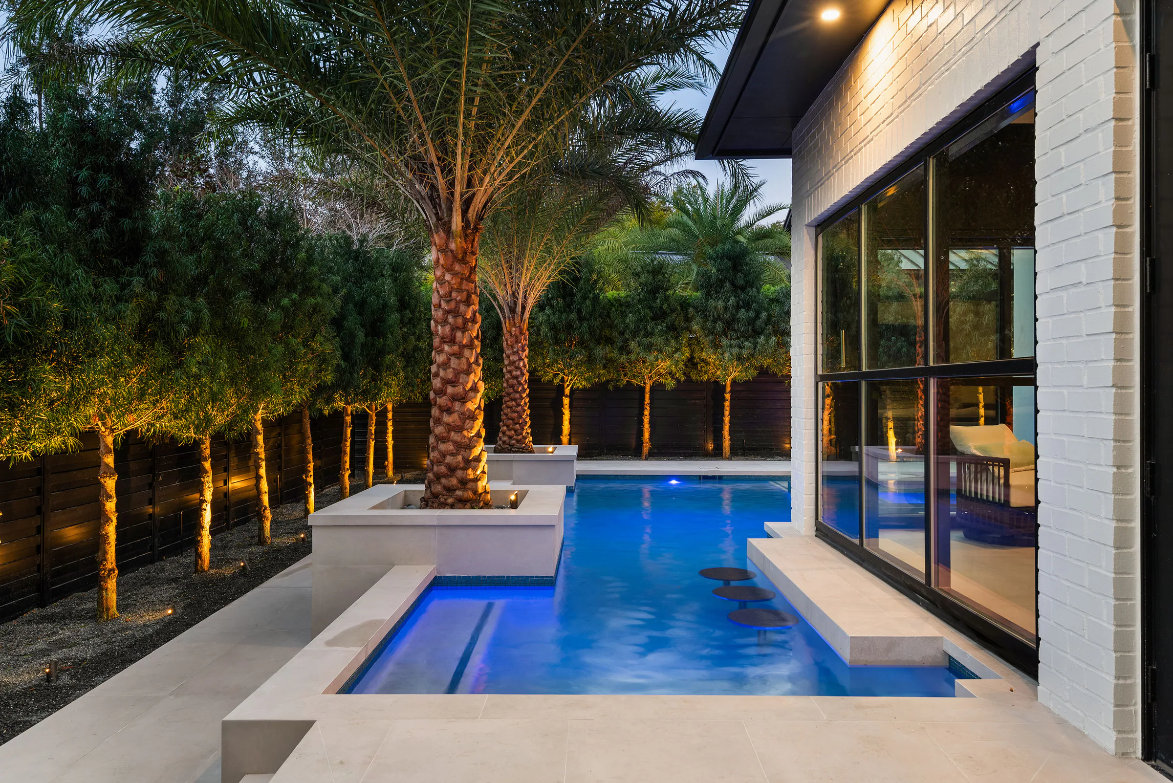 Pool and spa illuminated at blue hour. Rockwood, a custom home by Rare Builders in Orlando.