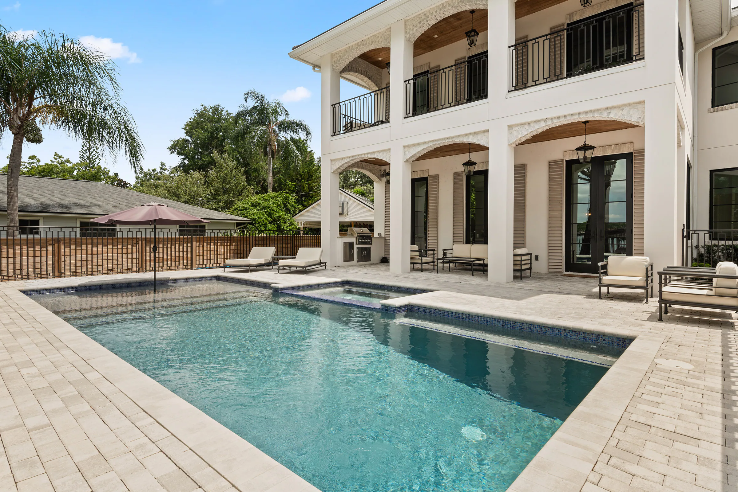 Rectangular pool and spa along the rear terrace. Killarney, a custom home by Rare Builders in Orlando.