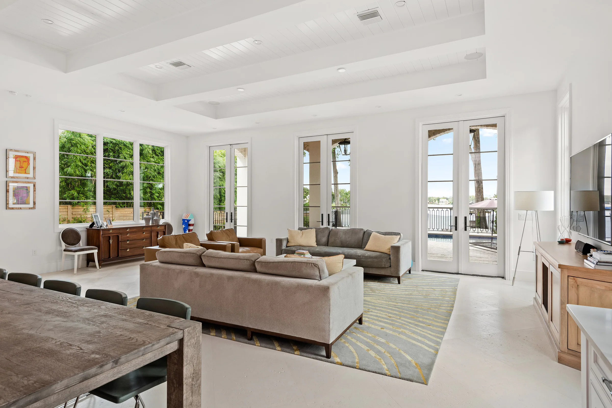 Living seating area with leather sofas beside the open kitchen.