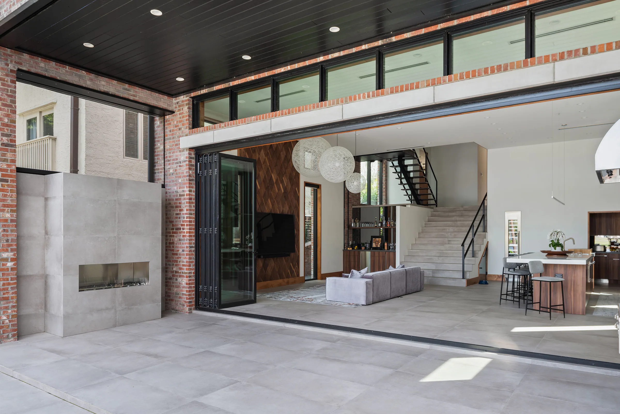 Covered outdoor room with dining and lounge areas. Terrace, a custom home by Rare Builders in Orlando.