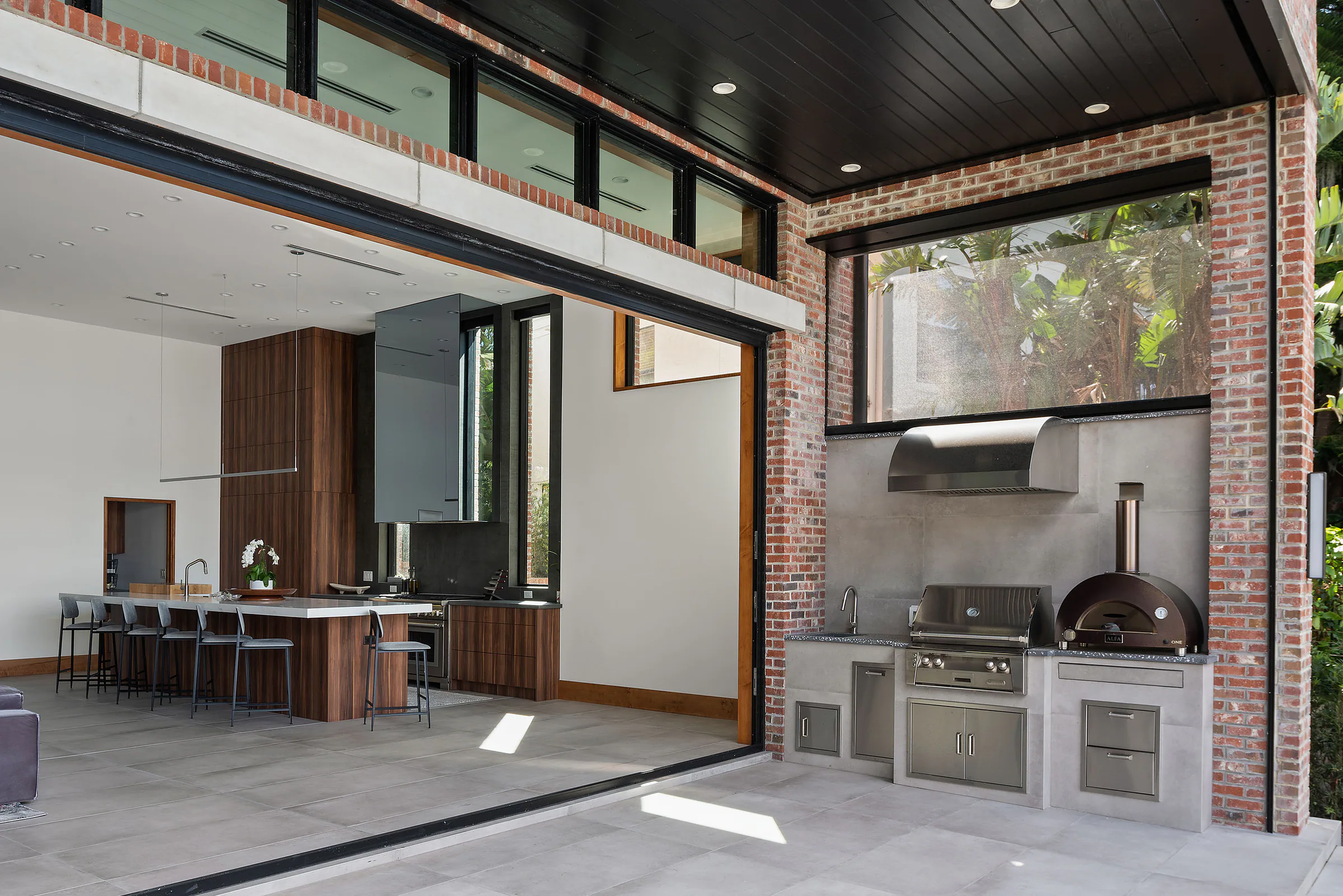 Florida Room with a built-in grill and pizza oven opening to the kitchen.